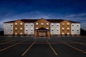 a large building in a parking lot at Quality Inn & Suites McAlester on Hwy 69 in McAlester