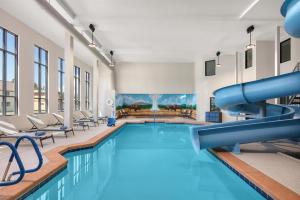 a swimming pool with a slide in a building at Starlite Yellowstone, Tapestry Collection by Hilton in West Yellowstone