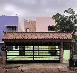 a building with a large garage with a building at Casa Pacifico Azul in Ixtapa