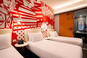 two beds in a room with an american flag wall at Radisson RED Miraflores in Lima