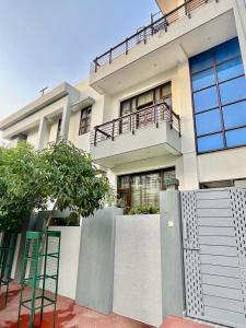 a white house with a fence in front of it at ZenRoofs-3 BHK Bungalow in Jaipur