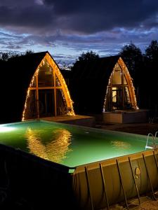 an igloo house with a pool at night at The House in Yaremche