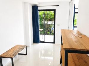a dining room with a wooden table and a bench at DM udon in Udon Thani