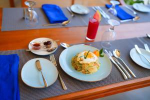 a table with a plate of food on a table at Cape Sigiriya in Sigiriya