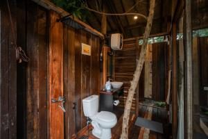 a bathroom with a toilet in a tree house at Folky House Sidemen in Silebeng