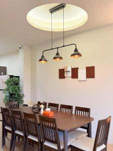 a dining room with a wooden table and chairs at 想睡覺民宿 in Hsia-ch'ing