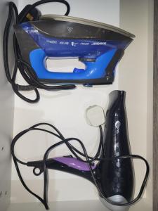 a iron and a hair dryer on a shelf at Chryso Apts Protaras in Protaras