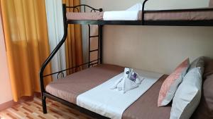 a room with two bunk beds and a couch at Victoria's Inn in Siquijor +8 photos