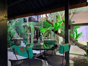 a patio with a table and chairs at The Lodge Canggu in Tumbak Bayuh