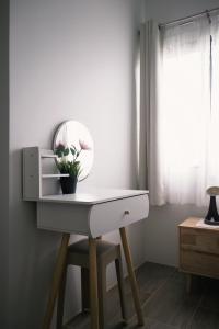 a white desk with a mirror and a plant on it at Prouds House in Ban Hua Phlong +135 photos