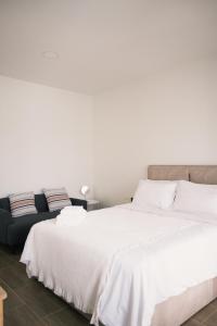 a bedroom with two beds and a couch at Prouds House in Ban Hua Phlong