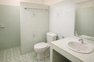 a white bathroom with a toilet and a sink at 169 Home Resort in Ban Huai Khram +10 photos