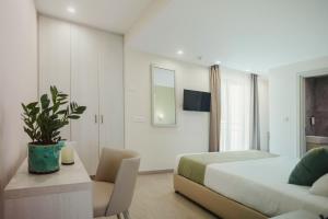 a bedroom with a bed and a table and a couch at Roseum Boutique Hotel in Larnaca