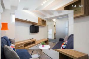 a living room with two couches and a mirror at City Holliday Lux in Belgrade