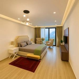 ein großes Schlafzimmer mit Bett und ein Wohnzimmer in der Unterkunft Park Ridge Hotel Serviced Apartments - Executive Valley View Apartment in Murree