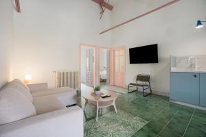 a living room with a couch and a table at Raízes 22 - Apartamento 4 in Puebla de Don Fadrique