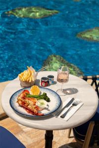a table with a plate of food and a glass of wine at Grand Hyatt Istanbul in Istanbul +136 photos