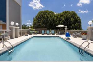a swimming pool on a balcony with chairs and tables at Hampton Inn Morristown in Morristown
