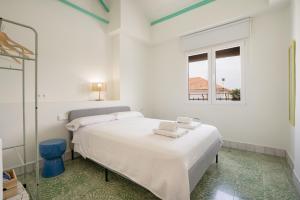 a white bedroom with a bed and a window at Raízes 22 - Apartamento 4 in Puebla de Don Fadrique +29 photos
