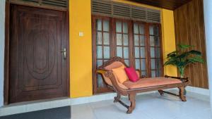 a chair with two pillows sitting in front of a door at Margarita Leisure in Wadduwa +34 photos