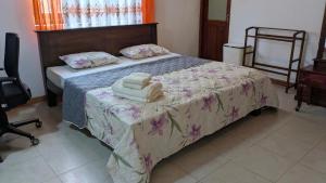 a bedroom with a bed with towels on it at Margarita Leisure in Wadduwa
