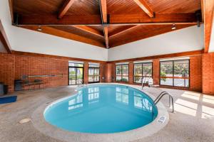an indoor pool in a building with a large room with windows at Spark By Hilton Staunton in Staunton