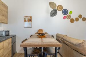 a kitchen with a wooden table and a couch at Casa Do Renque in Arzúa
