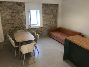 a living room with a table and a couch at HOLIDAY HOME m&n in Zaostrog