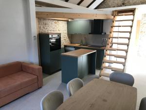 a kitchen with a table and a staircase in a room at HOLIDAY HOME m&n in Zaostrog
