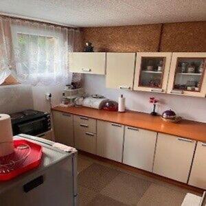 a kitchen with white cabinets and a counter top at Ostrzycki Raj in Pierszczewo