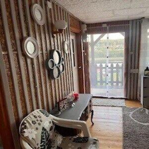 a living room with a striped wall with clocks at Ostrzycki Raj in Pierszczewo