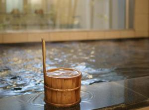 a wooden cup sitting on top of a table at Super Hotel Kushiro Kurogane in Kushiro