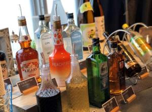a bunch of bottles of alcohol on a table at Super Hotel Kushiro Kurogane in Kushiro
