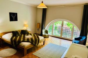 a bedroom with a bed and an arched window at Magnificent duplex in a former Palace in Chamonix