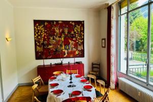 a dining room with a table and a painting on the wall at Magnificent duplex in a former Palace in Chamonix