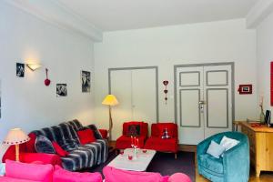 a living room with a couch and chairs and a table at Magnificent duplex in a former Palace in Chamonix