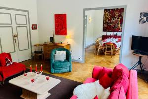 a living room with a couch and a table at Magnificent duplex in a former Palace in Chamonix +14 photos