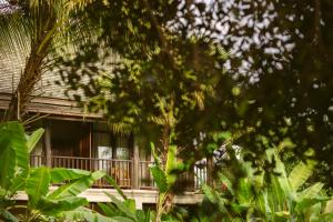 a house with a balcony in the midst of trees at Maison Dalabua in Luang Prabang +91 photos