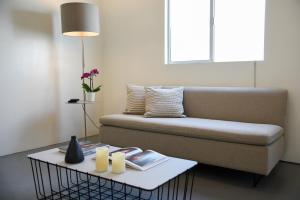 a living room with a couch and a table with candles at Hollywood Guesthouse in Los Angeles