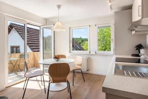 a kitchen and dining room with a table and chairs at Gästehaus Schwert in Salem