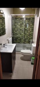 a bathroom with a toilet and a sink at EL RINCON DE LUZ in Padrón +38 photos