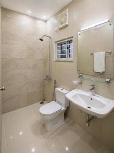a bathroom with a toilet and a sink at Studio 13 in Islamabad