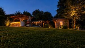a house with a gazebo in a yard at night at Hiška Miru Peace Cabin in Mozirje