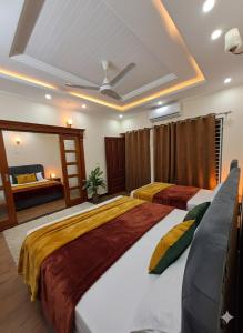 a bedroom with two beds and a mirror at Studio 13 in Islamabad