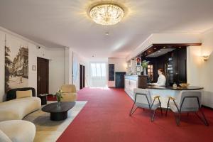 a living room with a couch and a table at Seehotel Kastanienbaum in Lucerne