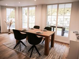 a dining room with a wooden table and chairs at Modern apartment in Seefeld in Reith bei Seefeld +17 photos