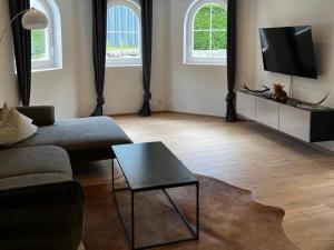 a living room with a couch and a coffee table at Modern apartment in Seefeld in Reith bei Seefeld