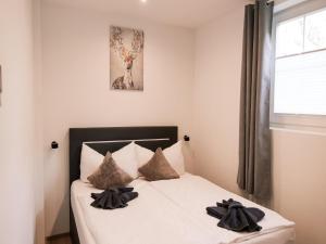 a bedroom with a bed with two pillows on it at Modern apartment in Seefeld in Reith bei Seefeld