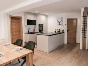 a kitchen and living room with a table and chairs at Modern apartment in Seefeld in Reith bei Seefeld