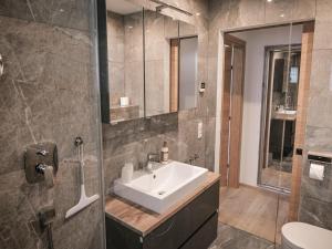 a bathroom with a sink and a shower at Modern apartment in Seefeld in Reith bei Seefeld